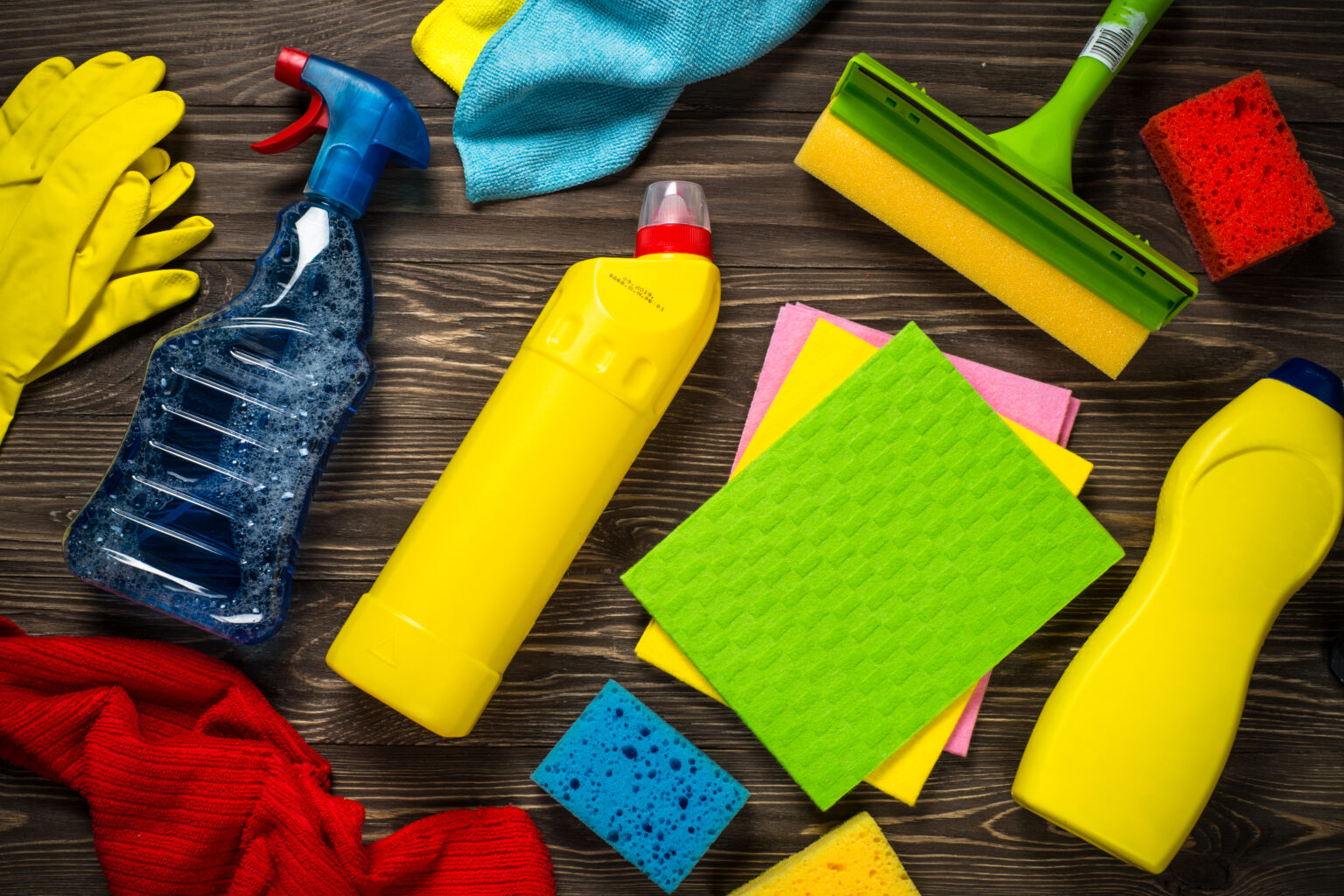 Cleaning product, household, sanitary supplies on wooden table. Top view.